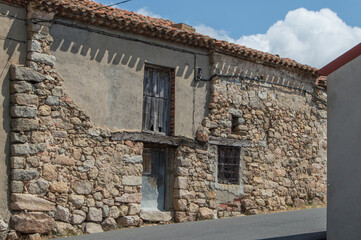 old abandoned rural house in with  wooden door and windows in street in Las Navas del Marques, province od Avila. Spain