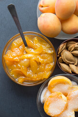 Apricot halves with sugar and jam in glass bowls. Steps for making apricot jam. Top view.
