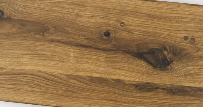 Rotation of natural oak texture. Surface with cracks and knots.