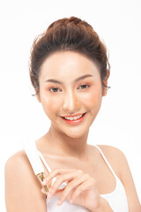 Beautiful Young Asian Woman Holding luxury white clean tube smile feeling so happy and cheerful with healthy Clean and Fresh skin,isolated on gray background,Beauty Cosmetics spa and treatment Concept