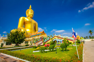 Beautiful of Large golden sitting Buddha statue with the background of blue sky at Wat Muang  temple,Ang Thaong, Thailand