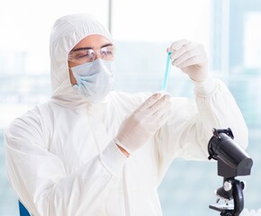 Fototapeta premium Young chemist student working in lab on chemicals