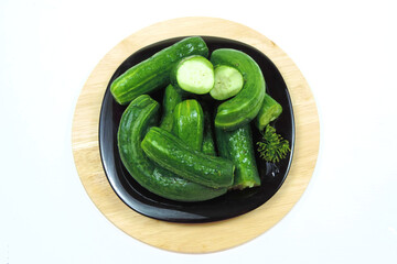      a little pickles on a black dish, summer pickles