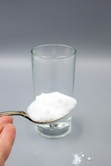 Transparent glass glass with water and white sorbent powder for treatment, ingestion for poisoning, allergies