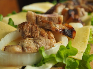 the chef prepares a sandwich from a French baguette with greens, cheese and meat. sandwich