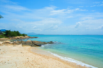 sea beach blue sky sand with rock sun daylight