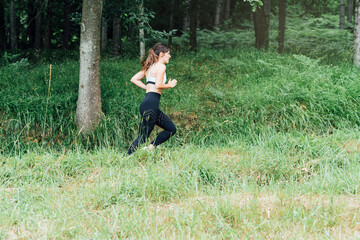 side view of a girl running through the forest