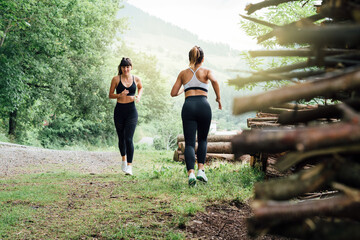 two beautiful girls cross paths running through the woods