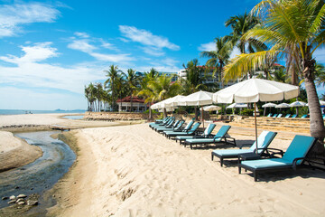 Beach chair with umbrella with blue sky on tropical beach.