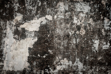 old cracked bulletin board wall with rests of paper