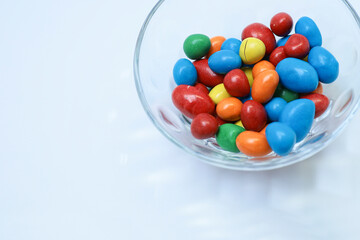 Close view of mixed color candy in a glass bowl 