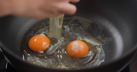 Crack egg on the grill pan