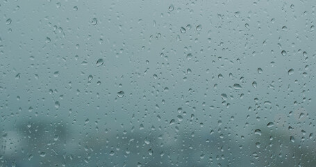 Heavy raining outside, rain on the window glass
