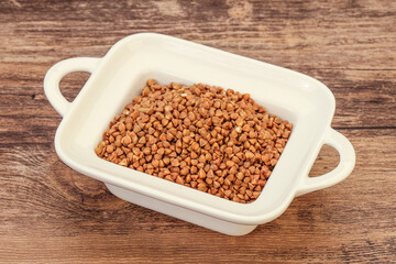 Raw buсkwheat cereal in the bowl