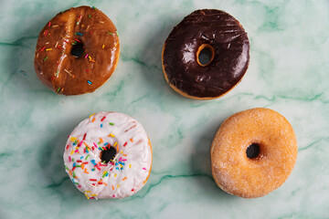 Four colorful donuts overview in a textured background