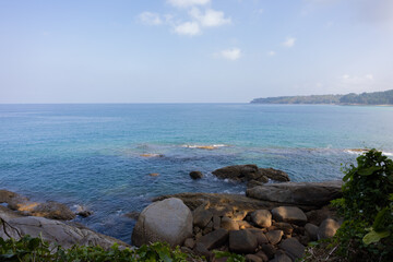 View of the rocky shore that washes the sea