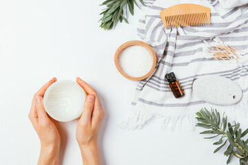 Flat lay female hands hold jar cream moisturizer