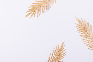 Flat lay composition of golden palm leaves