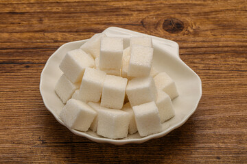 Refined white sugar cubs in the bowl