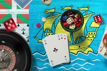 Saint Pierre And Miquelon casino theme. Aces in poker game, cards and chips on red table with national flag background. Gambling and betting.