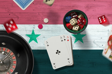 Syria casino theme. Aces in poker game, cards and chips on red table with national flag background....
