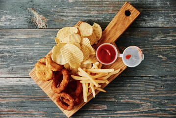 Unhealthy and junk food. Different types of fastfood and snacks on the table, closeup. Takeaway food