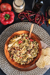 Overview of a bowl of mexican esquites with raw ingredients aside.