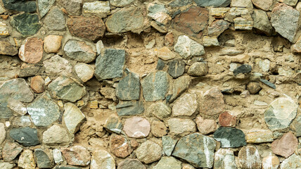 Fototapeta premium Wall of oval stones, backgrounds, textures