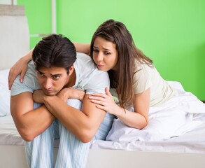 Fototapeta premium Young woman consoling disappointed impotent husband