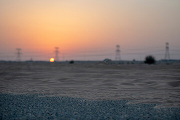Obraz premium High voltage power lines in the desert during sunset