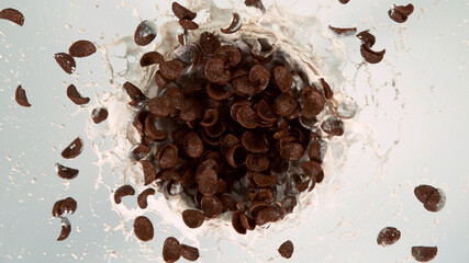 Freeze motion of rotating cereal pieces with milk splash