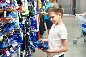 Boy with boots in a football store