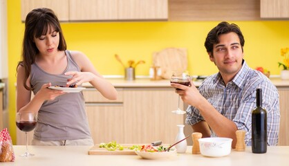 Young couple celebrating wedding anniversary at kitchen