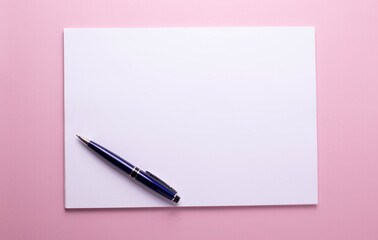 blank empty white shit of paper from a notebook on pink