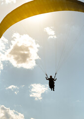 silhouette of a girl jumping on a paragliding