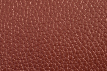 The texture of genuine leather. The texture of bovine skin. Macro photo. The skin is bovine. Relief skin texture. The surface of the product is made of genuine calf leather. Red abstract texture backg