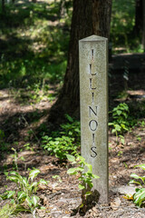 The name of the state Illinois engraved on a stone pillar in a park