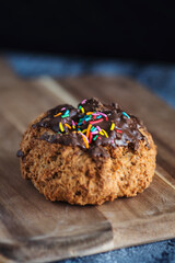Mexican pastry rock chocolate bun, close up on a wooden table