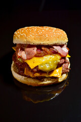 double bacon cheeseburger with black background