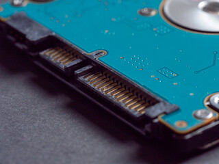 2.5 inch hard disk drive for laptop or computer on a dark paper background. close up, selective focus