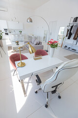 Cozy luxury modern interior design of a studio apartment in extra white colors with fashionable expensive furniture in a minimalist style. white tiled floor, kitchen, relaxation area and workplace