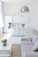 Cozy luxury modern interior design of a studio apartment in extra white colors with fashionable expensive furniture in a minimalist style. white tiled floor, kitchen, relaxation area and workplace