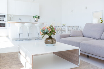 Cozy luxury modern interior design of a studio apartment in extra white colors with fashionable expensive furniture in a minimalist style. white tiled floor, kitchen, relaxation area and workplace