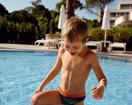 little cute real boy in swimming pool close up smiling
