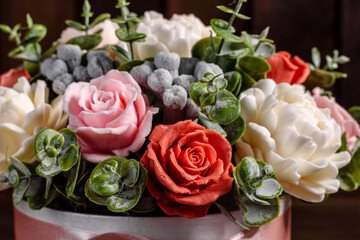 Bouquet of beautiful bright rose flowers in a gift cylindrical cardboard box