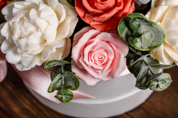 Bouquet of beautiful bright rose flowers in a gift cylindrical cardboard box
