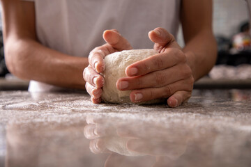 woman hands kneading pizza close-up