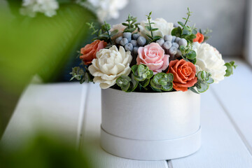 Bouquet of beautiful bright rose flowers in a gift cylindrical cardboard box