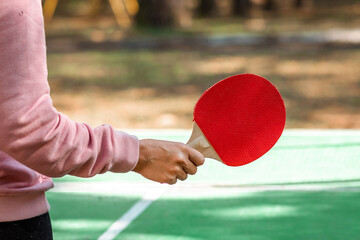 Ping pong rackets in hand close-up. The concept of a healthy lifestyle, sports games. Copy space, soft focus.
