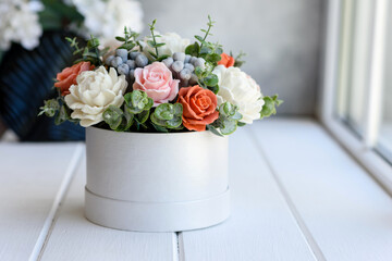 Bouquet of beautiful bright rose flowers in a gift cylindrical cardboard box